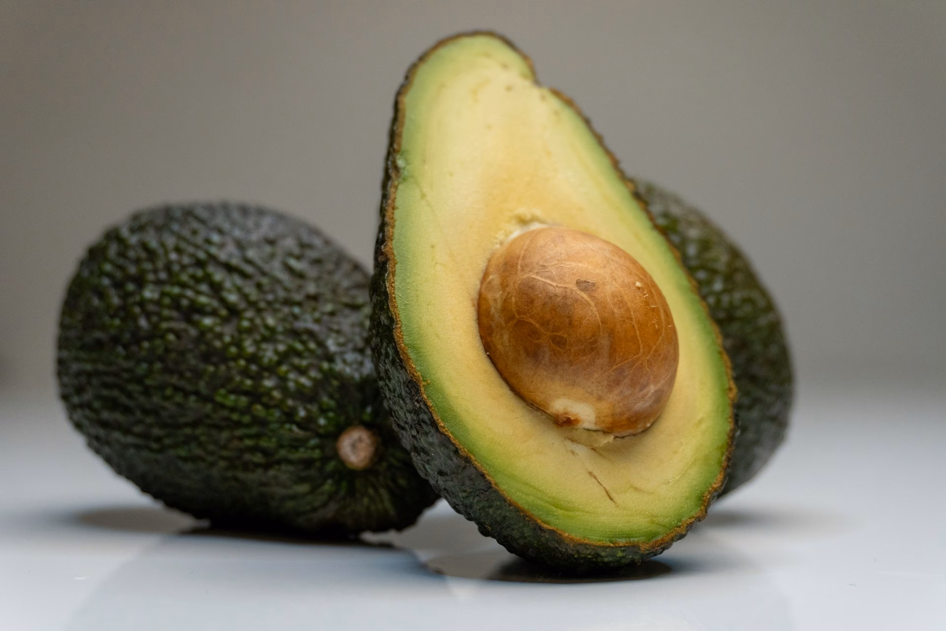 A ripe avocado cut in half