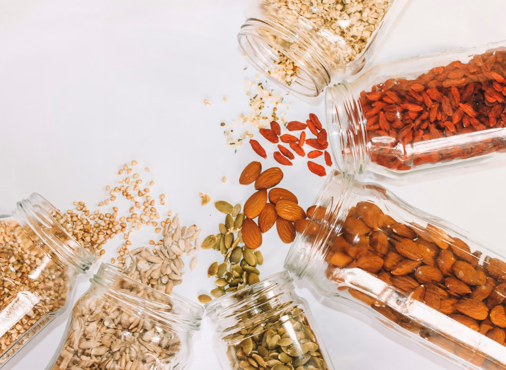 Spilled oats, seeds and cinnamon sticks on a surface