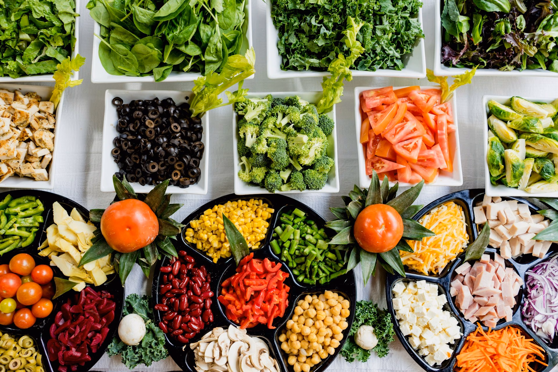 Bowls of colourful low-carb vegetables, nuts and seeds